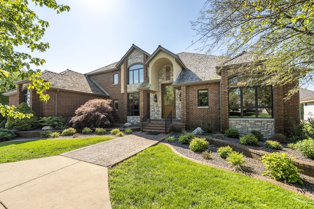 3596 E Montrose Ct, Springfield, MO 65809 - view of front facade featuring a front lawn, brick siding, a high end roof, and stone siding