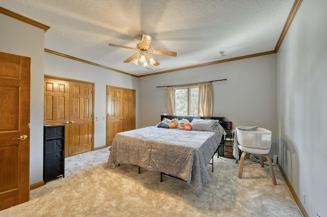 3596 E Montrose Ct, Springfield, MO 65809 - bedroom with crown molding, light carpet, two closets, a textured ceiling, and baseboards