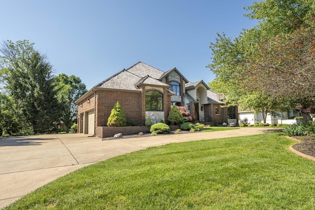 3596 E Montrose Ct, Springfield, MO 65809 - french country home with brick siding, driveway, a front lawn, and an attached garage
