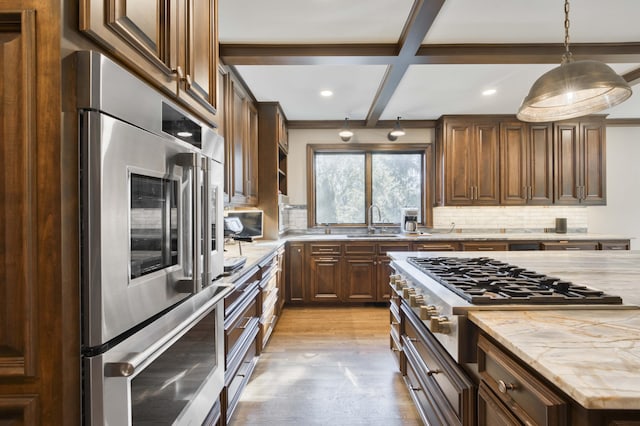 3596 E Montrose Ct, Springfield, MO 65809 - kitchen featuring appliances with stainless steel finishes, a sink, backsplash, light wood-style flooring, and light stone countertops