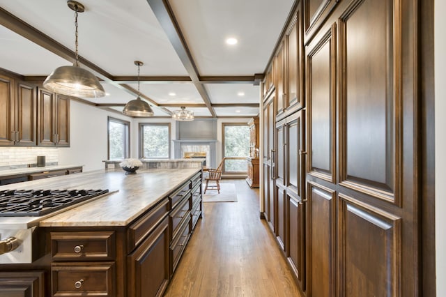 3596 E Montrose Ct, Springfield, MO 65809 - kitchen featuring healthy amount of natural light, wood finished floors, stainless steel gas cooktop, recessed lighting, and beamed ceiling
