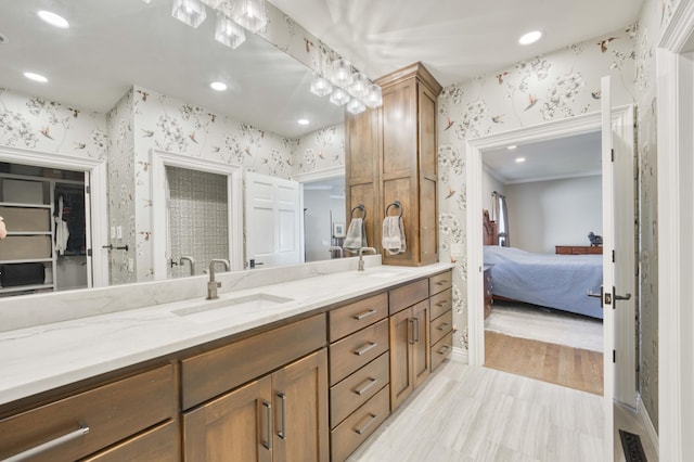 3596 E Montrose Ct, Springfield, MO 65809 - ensuite bathroom featuring wallpapered walls, double vanity, recessed lighting, a closet, and ornamental molding