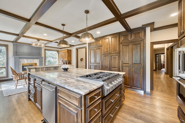 3596 E Montrose Ct, Springfield, MO 65809 - kitchen featuring stainless steel gas stovetop, coffered ceiling, light stone counters, light wood finished floors, and a center island