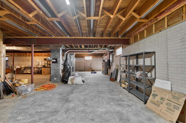 3596 E Montrose Ct, Springfield, MO 65809 - basement featuring water heater, heating unit, and brick wall