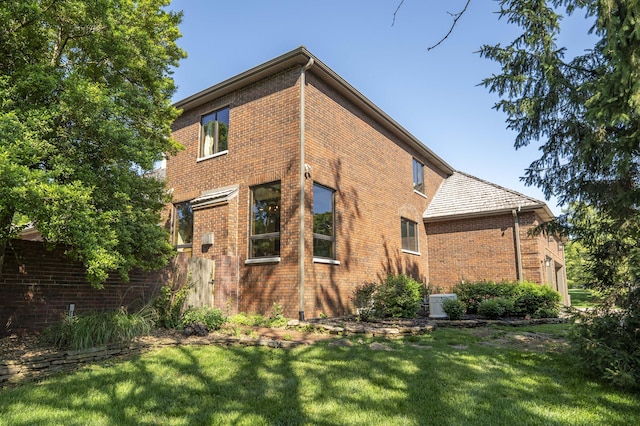 3596 E Montrose Ct, Springfield, MO 65809 - view of side of property with brick siding, a lawn, and cooling unit