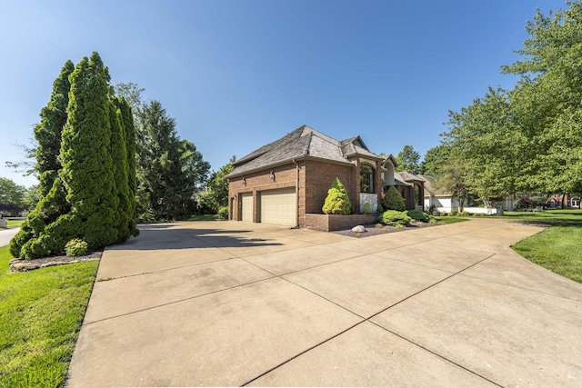 3596 E Montrose Ct, Springfield, MO 65809 - view of home's exterior with brick siding, concrete driveway, and a garage