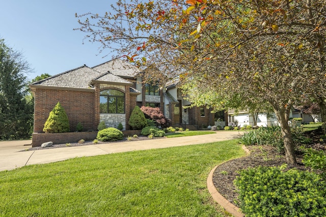 3596 E Montrose Ct, Springfield, MO 65809 - view of front of home featuring brick siding, a front lawn, and driveway