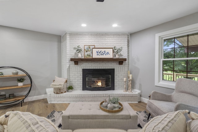 5715 S Clay Ave, Springfield, MO 65810 - living room featuring a brick fireplace, wood finished floors, baseboards, and recessed lighting