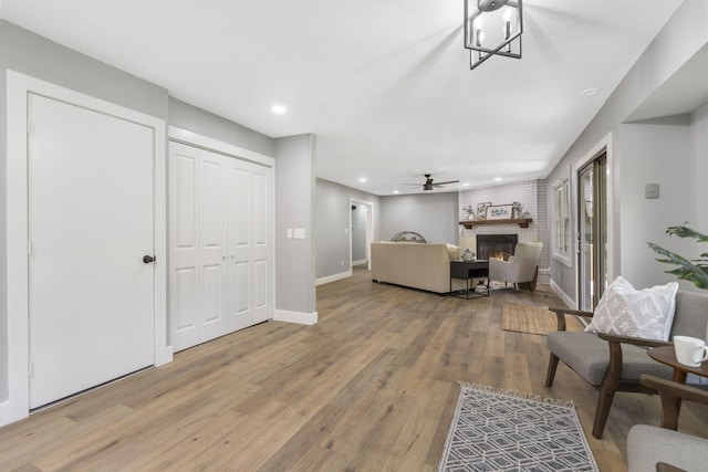 5715 S Clay Ave, Springfield, MO 65810 - living area with a fireplace, light wood finished floors, recessed lighting, ceiling fan, and baseboards