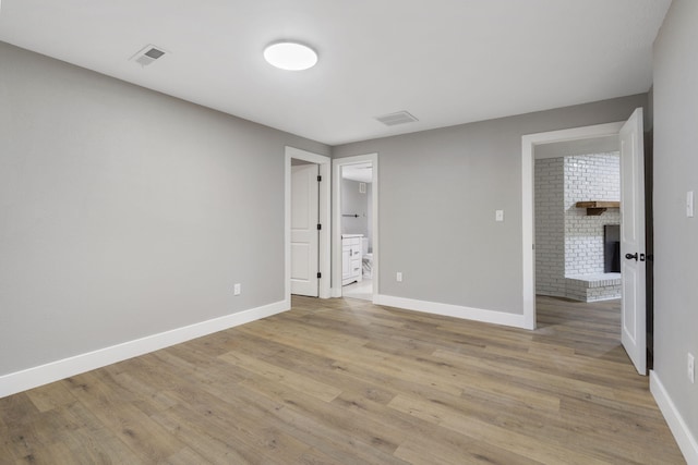 5715 S Clay Ave, Springfield, MO 65810 - unfurnished bedroom featuring baseboards, light wood finished floors, and ensuite bathroom