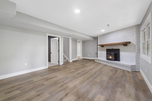 5715 S Clay Ave, Springfield, MO 65810 - unfurnished living room with baseboards, stairway, wood finished floors, a fireplace, and recessed lighting