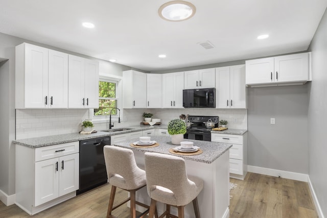 5715 S Clay Ave, Springfield, MO 65810 - kitchen with black appliances, a sink, baseboards, white cabinetry, and decorative backsplash