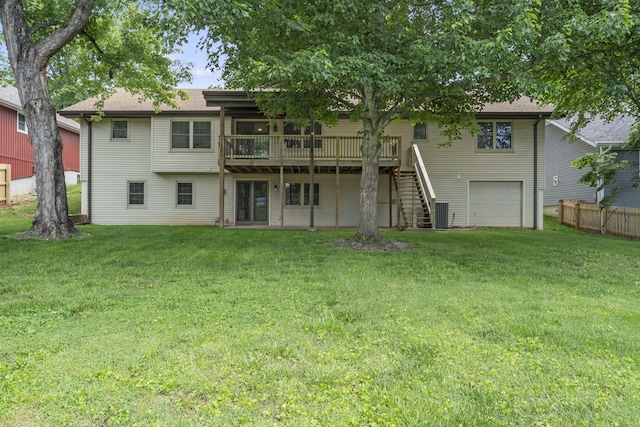 5715 S Clay Ave, Springfield, MO 65810 - back of house featuring a garage, a wooden deck, and stairs