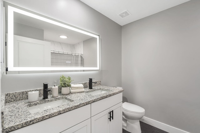 5715 S Clay Ave, Springfield, MO 65810 - full bathroom with double vanity, toilet, baseboards, and a shower with shower curtain