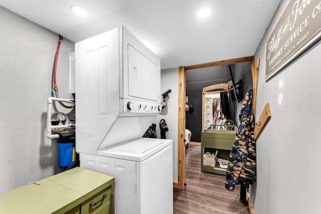 1939 E 540th Rd, Pleasant Hope, MO 65725 - laundry room featuring stacked washing machine and dryer, dark wood-style flooring, and recessed lighting
