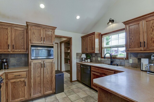 418 E Covington Rd, Willard, MO 65781 - kitchen with stainless steel appliances, a sink, lofted ceiling, backsplash, and brown cabinetry