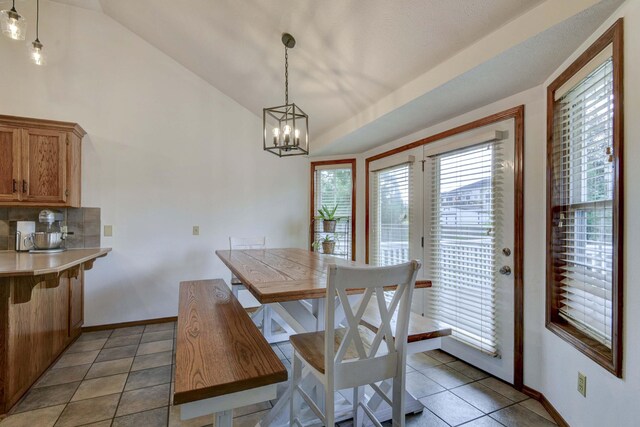 418 E Covington Rd, Willard, MO 65781 - dining space featuring light tile patterned flooring, a chandelier, lofted ceiling, and baseboards