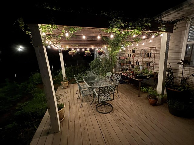 418 E Covington Rd, Willard, MO 65781 - deck at night featuring outdoor dining area and a pergola