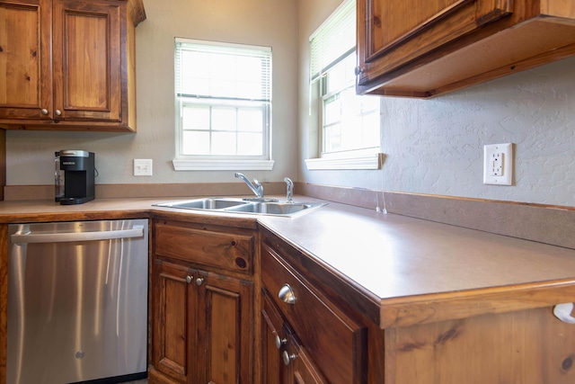 1214 Evington Ct, Springfield, MO 65803 - kitchen with dishwasher, a sink, brown cabinets, light countertops, and a textured wall