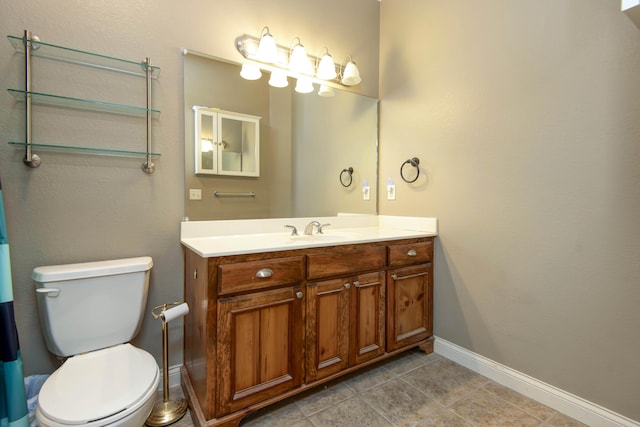 1214 Evington Ct, Springfield, MO 65803 - bathroom with vanity, toilet, baseboards, and tile patterned flooring