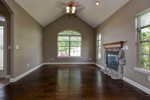 1214 Evington Ct, Springfield, MO 65803 - unfurnished living room with a ceiling fan, plenty of natural light, a stone fireplace, wood-type flooring, and lofted ceiling