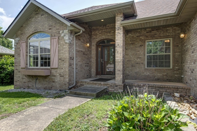 1214 Evington Ct, Springfield, MO 65803 - view of exterior entry with brick siding, roof with shingles, and covered porch