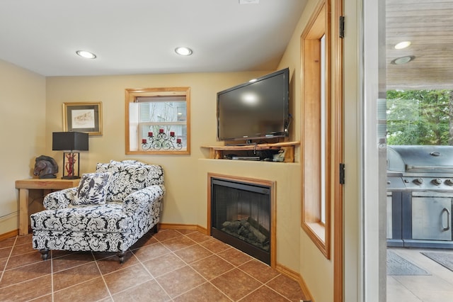 1041 Skyview Dr, Branson, MO 65616 - sitting room featuring a glass covered fireplace, tile patterned floors, baseboards, and recessed lighting