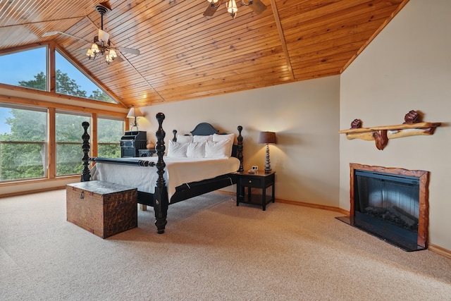 1041 Skyview Dr, Branson, MO 65616 - carpeted bedroom with vaulted ceiling, multiple windows, a glass covered fireplace, wooden ceiling, and baseboards