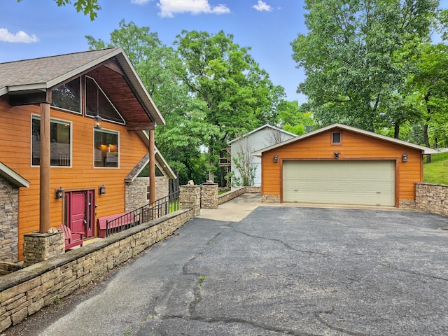 1041 Skyview Dr, Branson, MO 65616 - view of property exterior featuring an outdoor structure, a garage, and stone siding