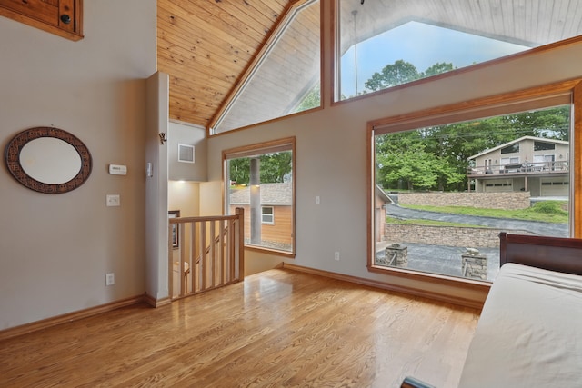 1041 Skyview Dr, Branson, MO 65616 - unfurnished living room featuring wooden ceiling, wood finished floors, high vaulted ceiling, and baseboards