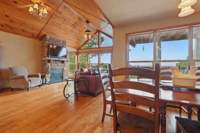 1041 Skyview Dr, Branson, MO 65616 - dining area with wood finished floors, a fireplace, high vaulted ceiling, wood ceiling with exposed beams, and a chandelier