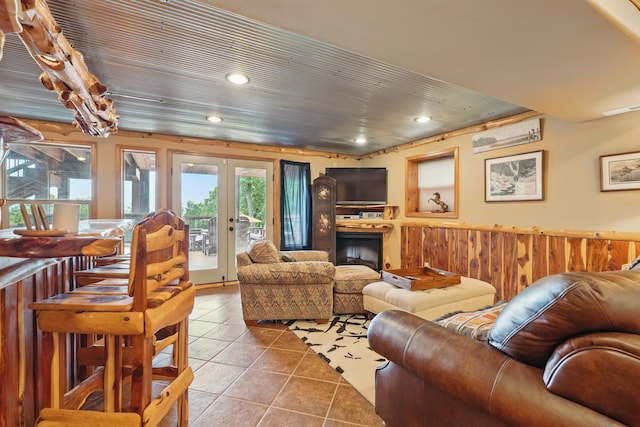 1041 Skyview Dr, Branson, MO 65616 - tiled living area featuring a wainscoted wall, french doors, recessed lighting, wood walls, and a fireplace