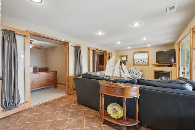 1041 Skyview Dr, Branson, MO 65616 - carpeted living room with recessed lighting, tile patterned floors, a ceiling fan, and a glass covered fireplace