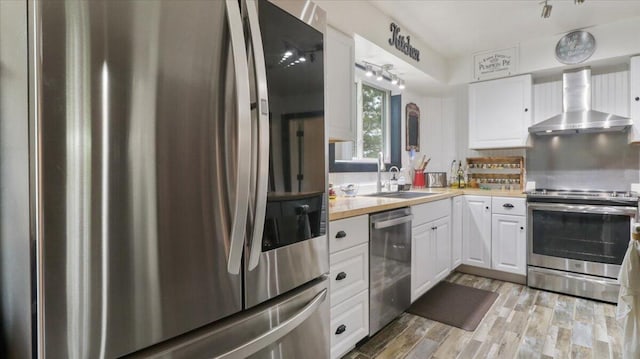53 County Road 803a, Gainesville, MO 65655 - kitchen with stainless steel appliances, wall chimney range hood, a sink, white cabinets, and light countertops
