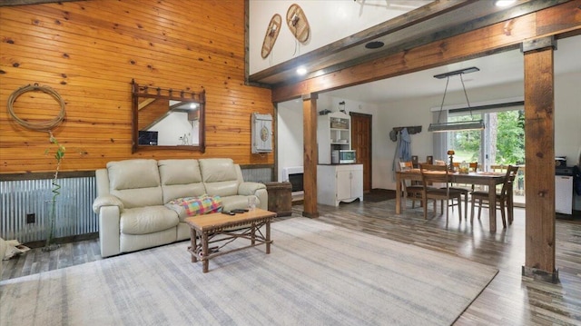 53 County Road 803a, Gainesville, MO 65655 - living room featuring wooden walls, wood finished floors, and a towering ceiling