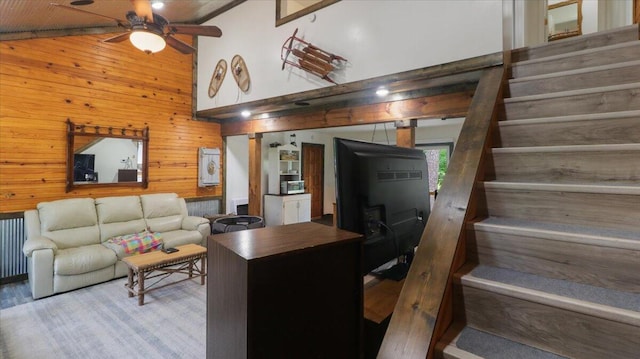 53 County Road 803a, Gainesville, MO 65655 - living area with wood walls, a ceiling fan, stairs, and high vaulted ceiling