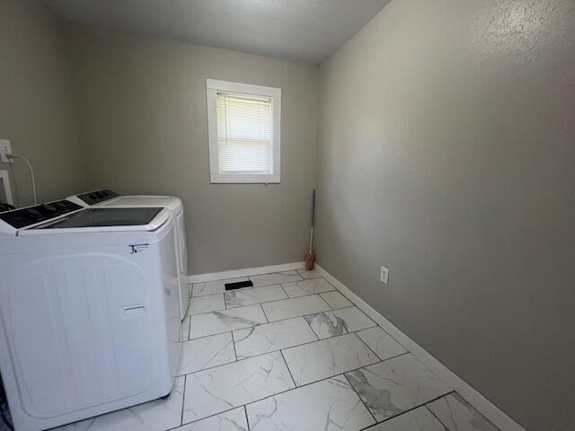 1217 Blair St, Cabool, MO 65689 - laundry area with washer and dryer, light marble finish flooring, and baseboards