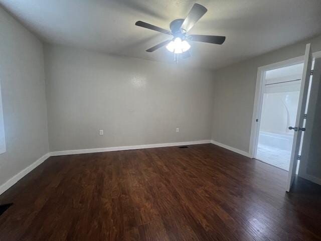 1217 Blair St, Cabool, MO 65689 - spare room featuring dark wood-type flooring, a ceiling fan, and baseboards