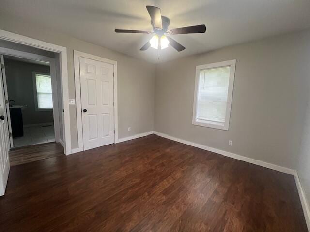 1217 Blair St, Cabool, MO 65689 - unfurnished bedroom featuring dark wood-style floors, baseboards, and ceiling fan