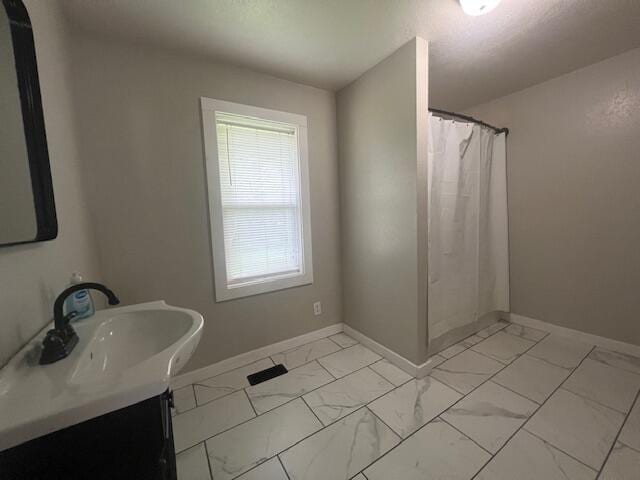 1217 Blair St, Cabool, MO 65689 - full bathroom featuring marble finish floors, vanity, and baseboards