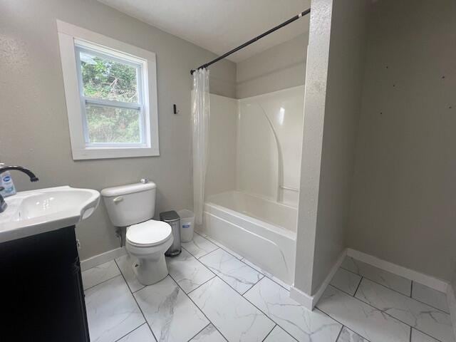 1217 Blair St, Cabool, MO 65689 - full bathroom featuring marble look tile flooring, baseboards, toilet, vanity, and shower / bath combination with curtain