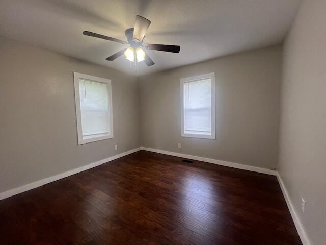 1217 Blair St, Cabool, MO 65689 - empty room with dark wood-type flooring, ceiling fan, and baseboards