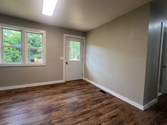 1217 Blair St, Cabool, MO 65689 - doorway featuring baseboards and dark wood-style flooring