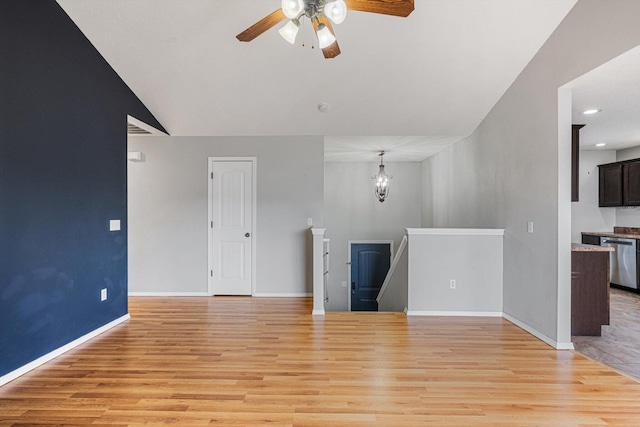 1311 Nitro Dr, Ozark, MO 65721 - unfurnished living room featuring ceiling fan, light wood-type flooring, baseboards, recessed lighting, and a chandelier