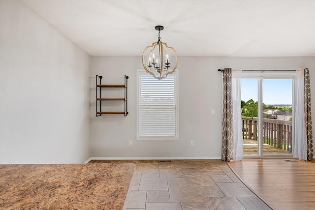 1311 Nitro Dr, Ozark, MO 65721 - unfurnished dining area with a chandelier and baseboards