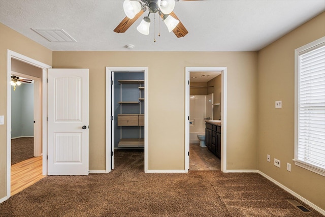 1311 Nitro Dr, Ozark, MO 65721 - unfurnished bedroom with dark carpet, a spacious closet, and ensuite bathroom