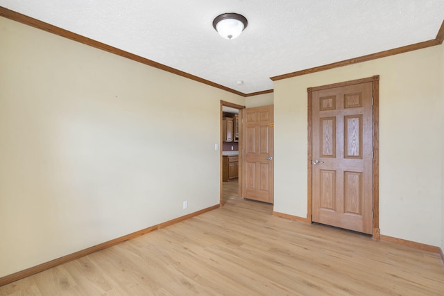 323 Shadrack Rd, Cape Fair, MO 65624 - unfurnished bedroom with light wood-type flooring, baseboards, crown molding, and a textured ceiling