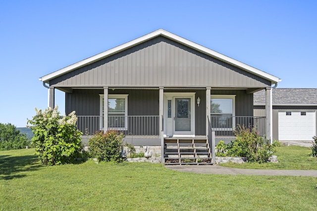 323 Shadrack Rd, Cape Fair, MO 65624 - view of front of home with covered porch, a front yard, and a garage