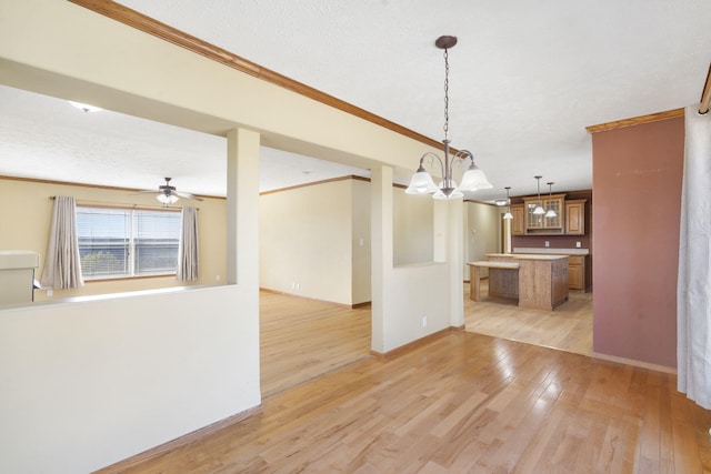 323 Shadrack Rd, Cape Fair, MO 65624 - unfurnished living room with light wood-type flooring, ornamental molding, a chandelier, baseboards, and ceiling fan