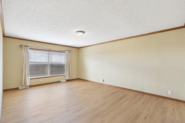323 Shadrack Rd, Cape Fair, MO 65624 - unfurnished room with crown molding, light wood-style floors, baseboards, and a textured ceiling